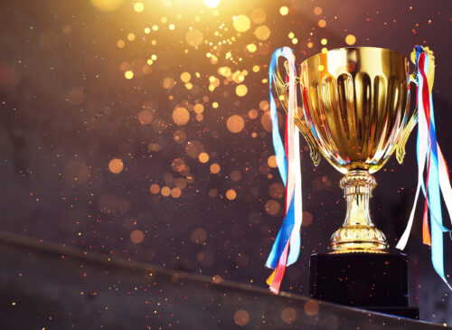 Low key golden trophy on the blur gray background with abstract trofeo 5 stelle d'oro della cucina